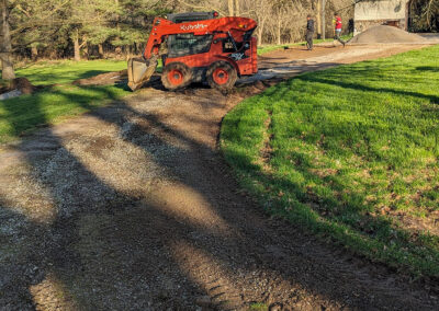 leveling is part of the process of chip sealing this long driveway in Michigan